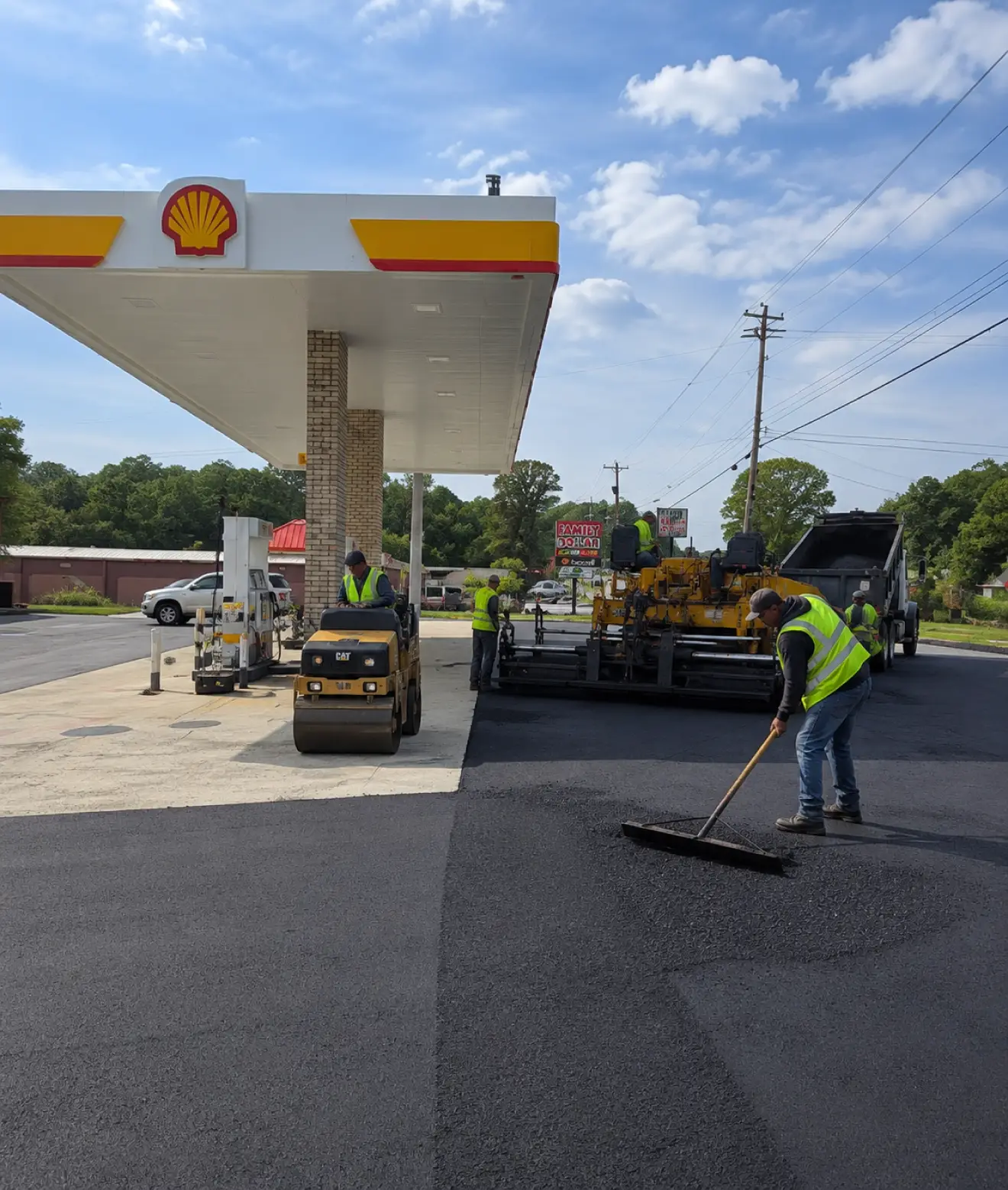 Commercial asphalt paving crew resurfacing a gas station parking lot in Georgia