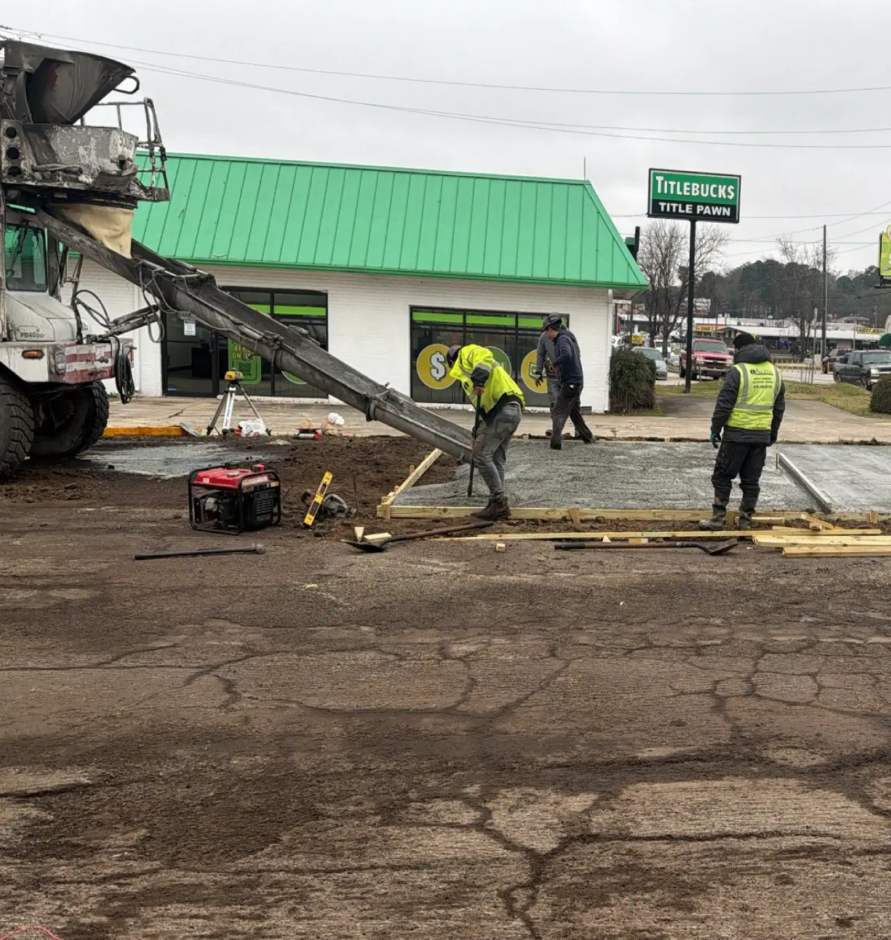 Commercial asphalt crew applying fresh sealcoating to a retail parking lot